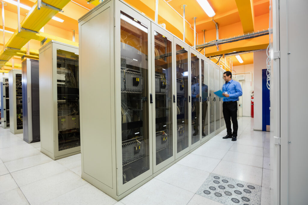 Man standing in data center aisle